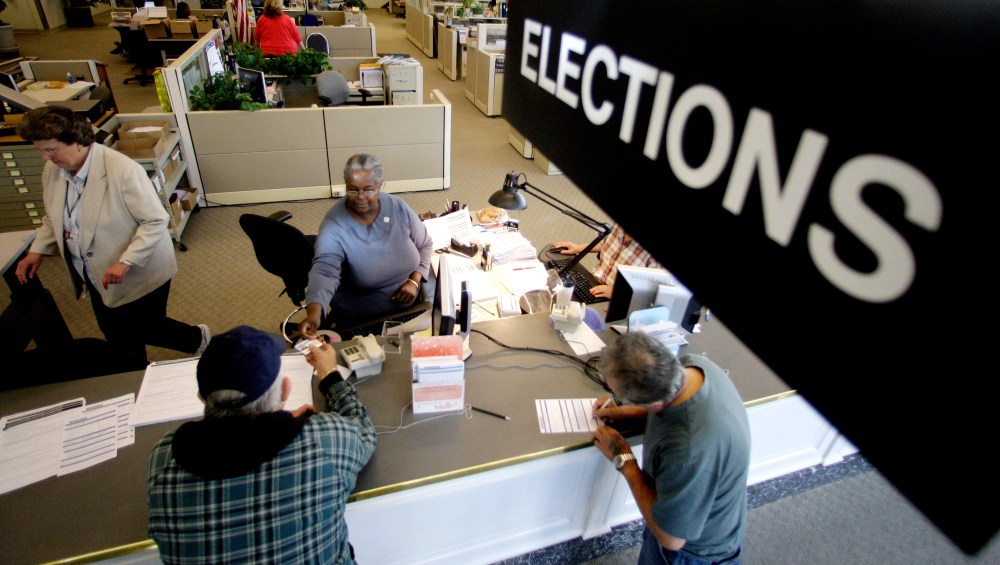 Voters drop their voters registration at Multnomah County Elections Office on Oct. 14, 2008, in Portland, Ore., on the final day for voter registration in Oregon. (Photo by Rick Bowmer/AP)