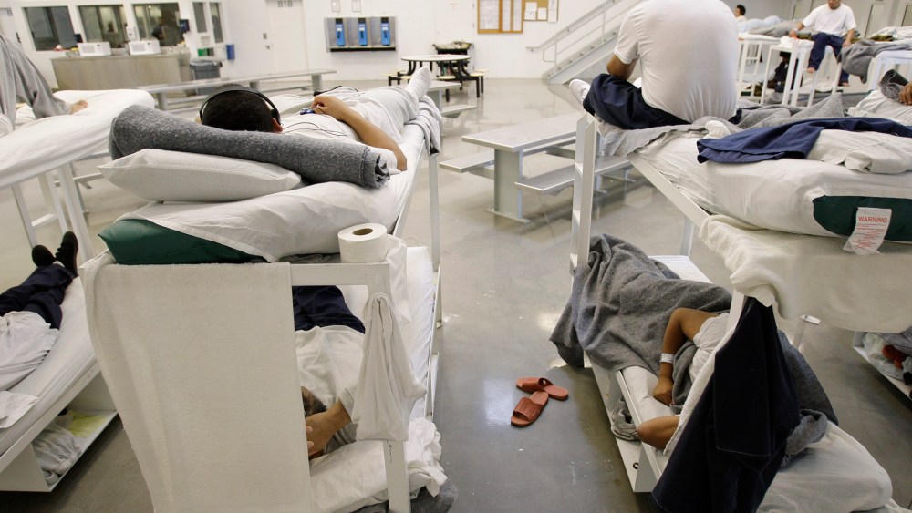 Detainees rest on bunks inside the "B" cell and bunk unit of the Northwest Detention Center in Tacoma, Wash.
