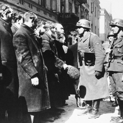 Nazi officers talk with citizens of the Warsaw ghetto, Poland, spring 1943. (Photo by AP)