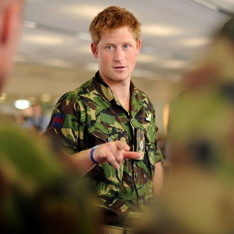 Prince Harry speaks with RAF personnel during a visit to RAF Honington Station in Suffolk, England on July 14, 2010. (Photo by Ben Stansall/PA Wire/AP)