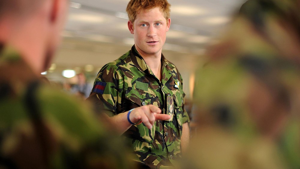Prince Harry speaks with RAF personnel during a visit to RAF Honington Station in Suffolk, England on July 14, 2010. (Photo by Ben Stansall/PA Wire/AP)