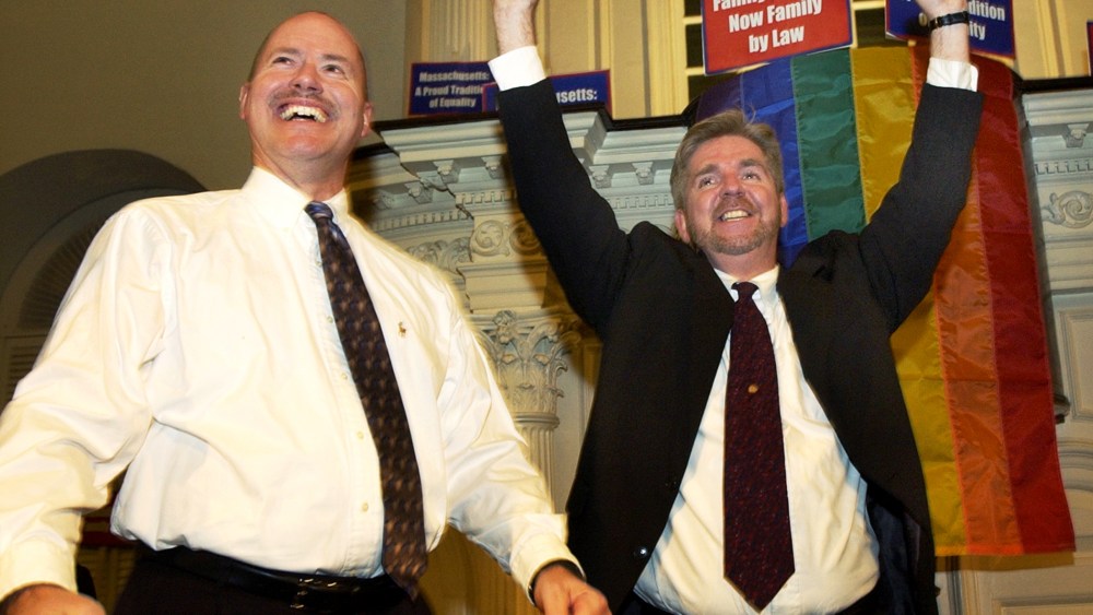 Ed Balmelli, left, and Michael Horgan of Boston, one of seven gay couples who sued the state of Massachusetts, celebrate during a rally at the Old South Meeting House in Boston on Nov. 18, 2003 after the Massachusetts Supreme Judicial Court's ruling that