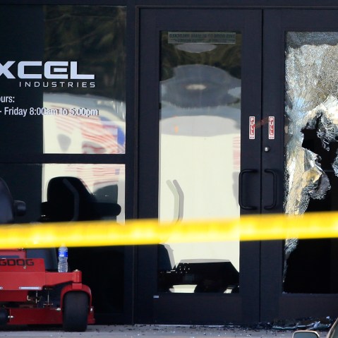 Shattered glass and bullet holes are seen at the front door of Excel Industries in Hesston, Kan., Feb. 26, 2016. Harvey County Sheriff T. Walton identified the gunman as Cedric Ford. (Photo by Orlin Wagner/AP)