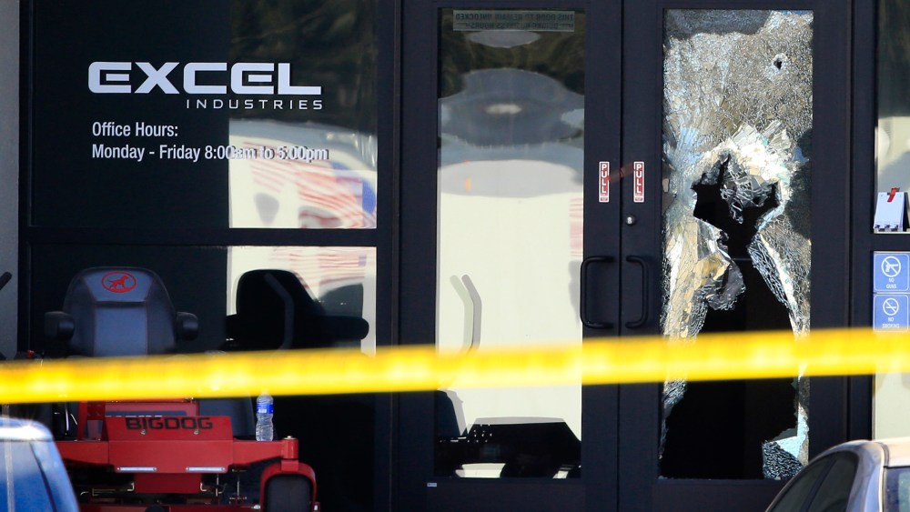 Shattered glass and bullet holes are seen at the front door of Excel Industries in Hesston, Kan., Feb. 26, 2016. Harvey County Sheriff T. Walton identified the gunman as Cedric Ford. (Photo by Orlin Wagner/AP)