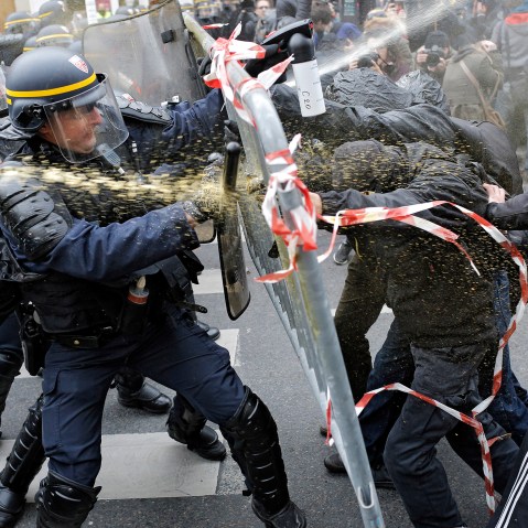 Policemen fight with activists during a protest ahead of the 2015 Paris Climate Conference at the Place de la Republique, in Paris, Nov. 29, 2015. (Photo by Laurent Cipriani/AP)