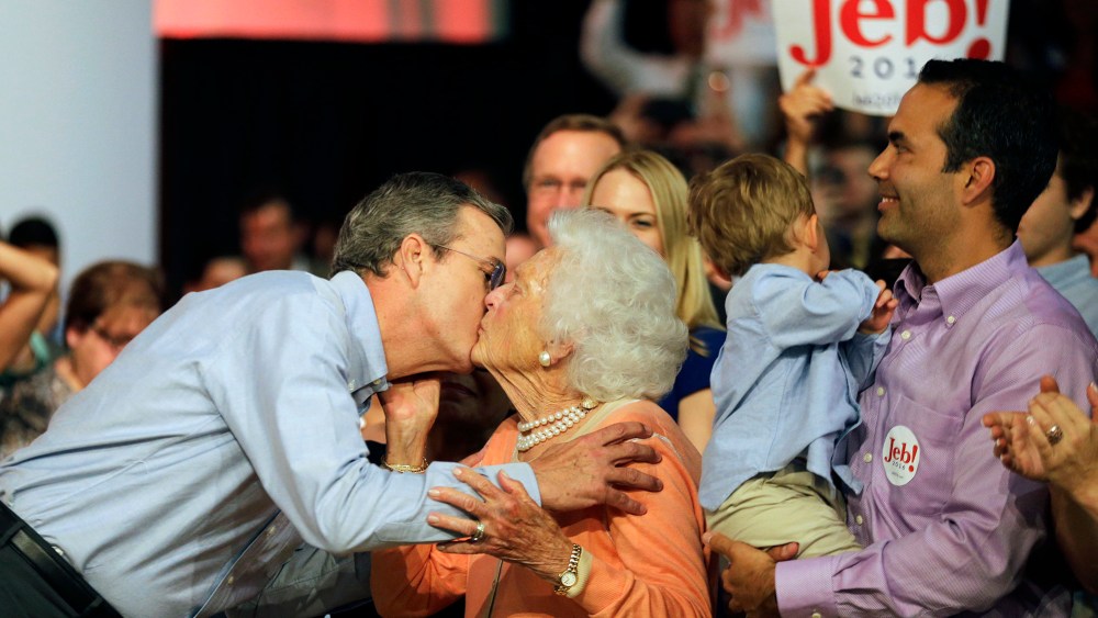 Former Florida Gov. Jeb Bush, left, kisses his mother Barbara as his son George, right, watches as he takes the stage to formally join the race for president with a speech at Miami Dade College, June 15, 2015, in Miami. (Photo by David Goldman/AP)