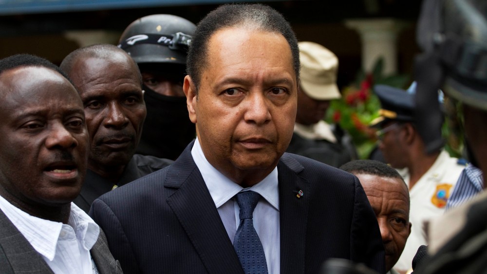 Haiti's ex-dictator Jean-Claude Duvalier is escorted out of his hotel in Port-au-Prince, Haiti Jan. 18, 2011. (Photo by Ramon Espinosa/AP)
