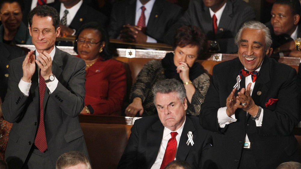 Rep. Anthony Weiner, D-N.Y., left, and Rep. Charles Rangel, D-N.Y., right stand and applaud as Rep. Peter King, R-N.Y. sits during President Barack Obama's State of the Union address in Washington, Tuesday, Jan. 25, 2011.