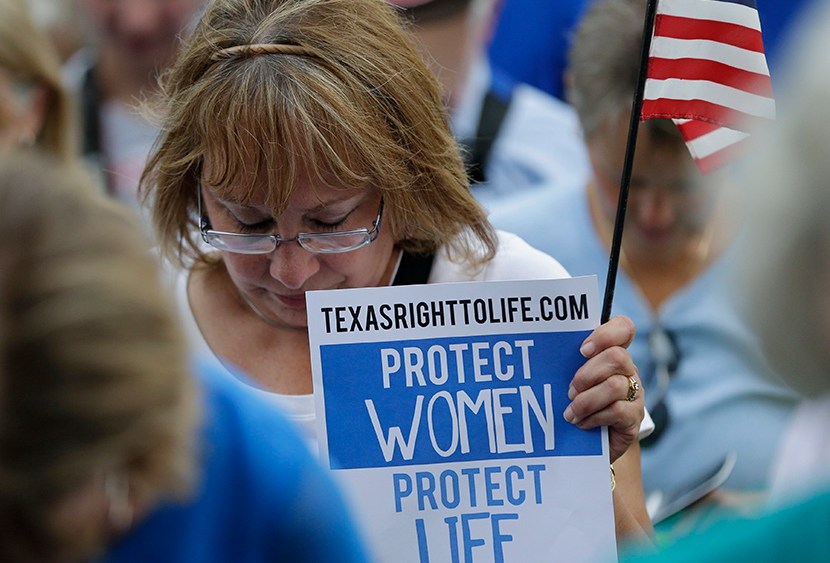 Supporters of an abortion bill pray during an anti-abortion rally at the Texas Capitol, Monday, July 8, 2013, in Austin, Texas. (Photo by Eric Gay/AP)