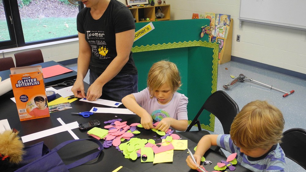 File Photo:  Parent volunteer Trinity Laurino, left, works on bulletin board decorations at Toomer Elementary School in Atlanta with her daughter, Olivia Laurino, center, and friend, Jake Jonsson in Atlanta. Atlanta Public Schools returns to classes...