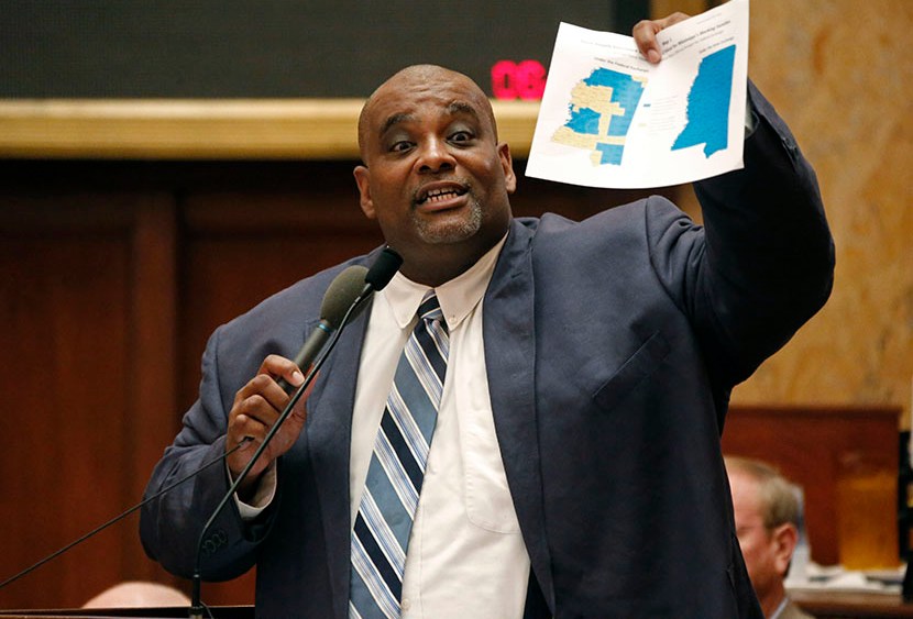 Rep. John Hines, Sr., D-Greenville, waves a map showing counties that are not part of the federal health insurance exchange as he calls on lawmakers to make health care more accessible to hundreds of thousands of uninsured people by expanding the...