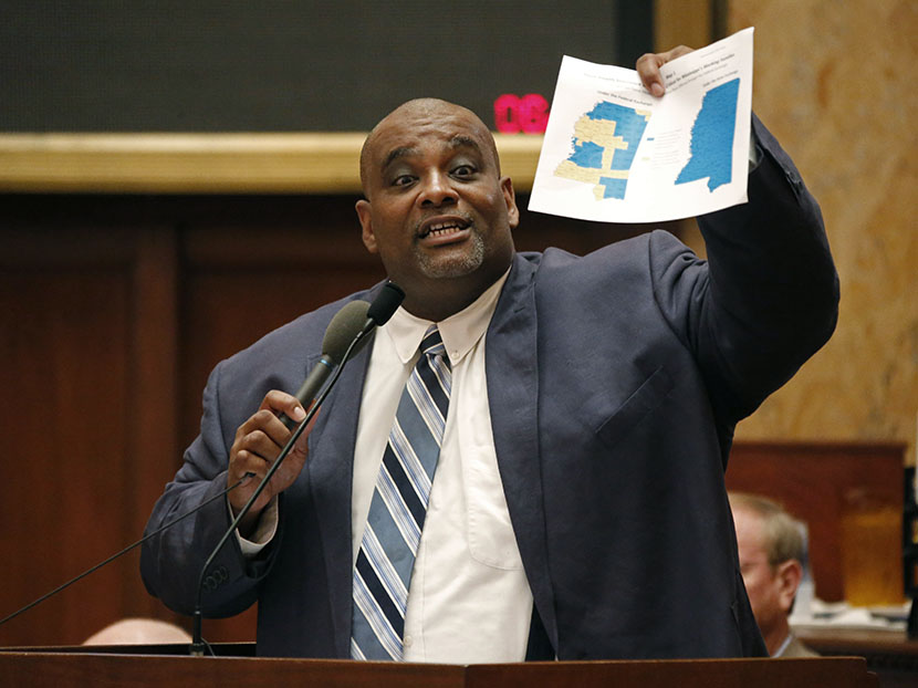 Rep. John Hines, Sr., D-Greenville, waves a map showing counties that are not part of the federal health insurance exchange as he calls on lawmakers to make health care more accessible to hundreds of thousands of uninsured people by expanding the...