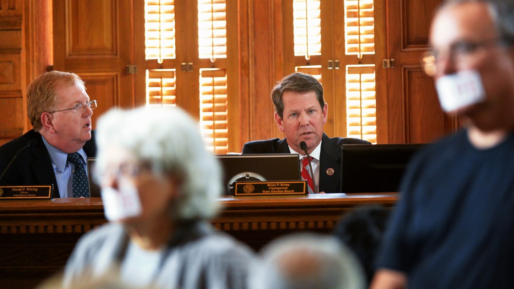 Brian Kemp, background right, Chairman of State Election Board, and David Worley, left, member of State Election Board, during a meeting to lay out the case of alleged voter registration fraud against the New Georgia Project at the Georgia State Capitol o