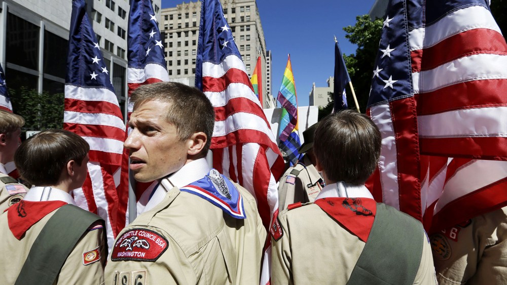 Boy Scouts from the Chief Seattle Council carry U.S. flags as they prepare to march in the Gay Pride Parade in downtown Seattle, June 30, 2013.