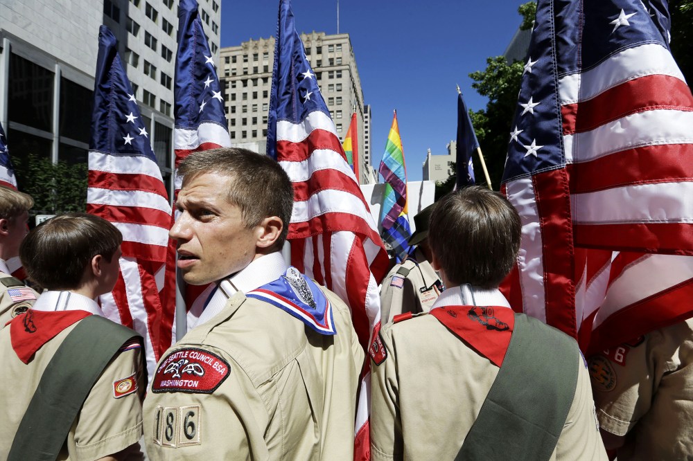 Boy Scouts from the Chief Seattle Council carry U.S. flags as they prepare to march in the Gay Pride Parade in downtown Seattle, June 30, 2013.