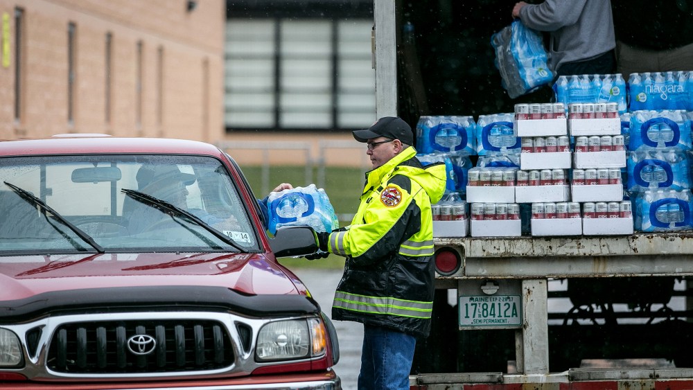 Members of the Nitro Volunteer Fire Department distribute water to local residents following the chemical spill, Jan. 10, 2014 in Charleston, W.V.