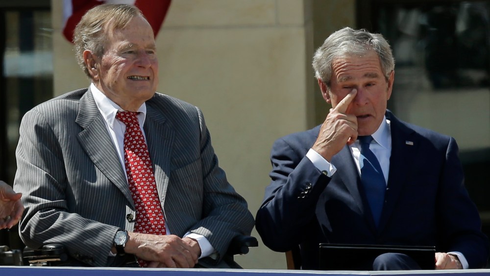 Former president George W. Bush wipes a tear after his speech during the dedication of the George W. Bush Presidential Center Thursday, April 25, 2013, in Dallas. Former president George H.W. Bush is at left. (AP Photo/David J. Phillip)