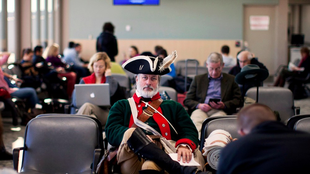 Tea party supporter William Temple sits in the Des Moines Airport, Wednesday, Jan. 4, 2012, in Iowa.