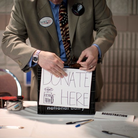 A volunteer prepares a donation box before a campaign stop by Republican presidential candidate, former House Speaker Newt Gingrich, Feb. 28, 2012, in Dalton, Ga. (Photo by Evan Vucci/AP)