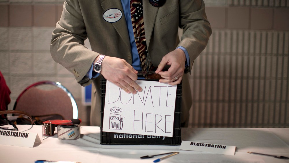 A volunteer prepares a donation box before a campaign stop by Republican presidential candidate, former House Speaker Newt Gingrich, Feb. 28, 2012, in Dalton, Ga. (Photo by Evan Vucci/AP)