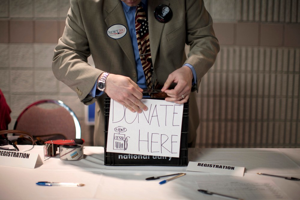 A volunteer prepares a donation box before a campaign stop by Republican presidential candidate, former House Speaker Newt Gingrich, Feb. 28, 2012, in Dalton, Ga. (Photo by Evan Vucci/AP)