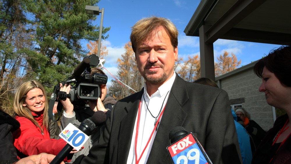 The Rev. Frank Schaefer, center, of Lebanon Pa., is surrounded by the media as he exits the gymnasium for a lunch break from a penalty hearing, at Camp Innabah, a United Methodist retreat, in Spring City Pa., Nov. 19, 2013.