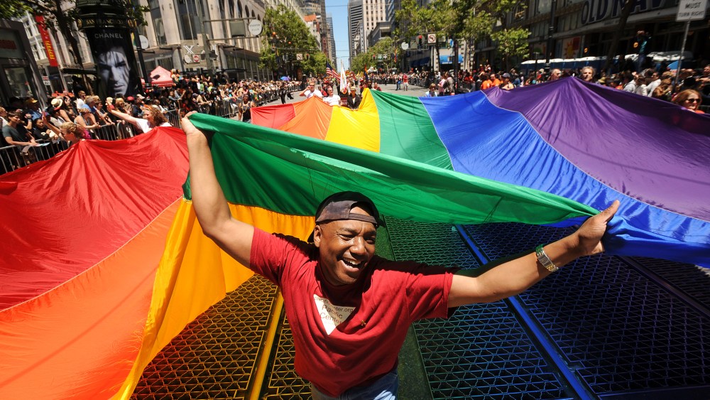 Mark Wilson carries a rainbow flag during San Francisco's 42nd annual gay pride parade, June 24, 2012.