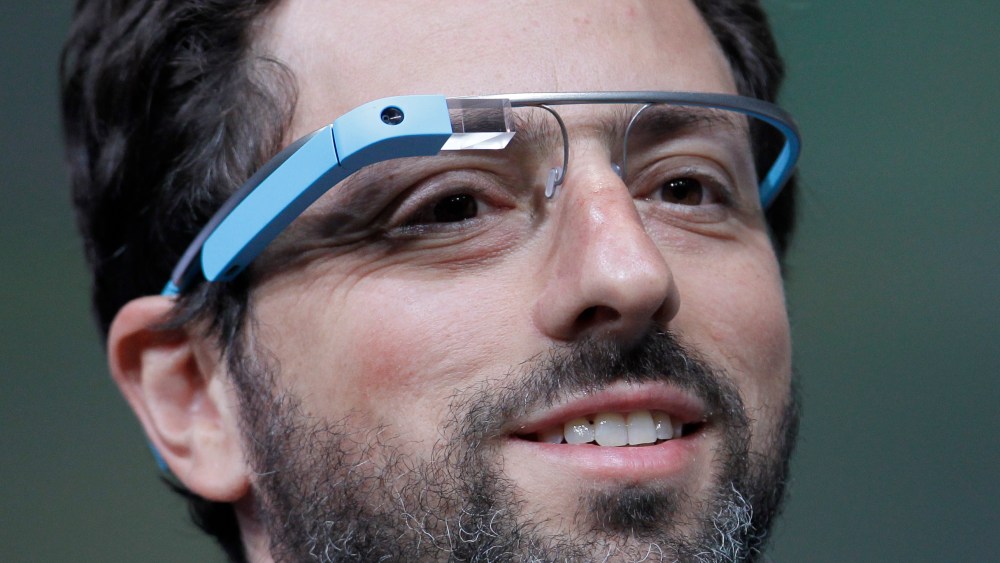 Google co-founder Sergey Brin demonstrates Google's new Glass, wearable internet glasses, at the Google I/O conference in San Francisco, Wednesday, June 27, 2012.  (AP Photo/Paul Sakuma)
