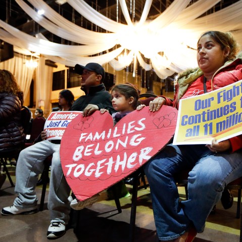 Maria Estrada, right, sits with her daughter, Janessa, 4, and husband, Servando Rivas, as they watch a broadcast of President Barack Obama annoucing executive actions on immigration on Nov. 20, 2014, in Nashville, Tenn. (Photo by Mark Humphrey/AP)