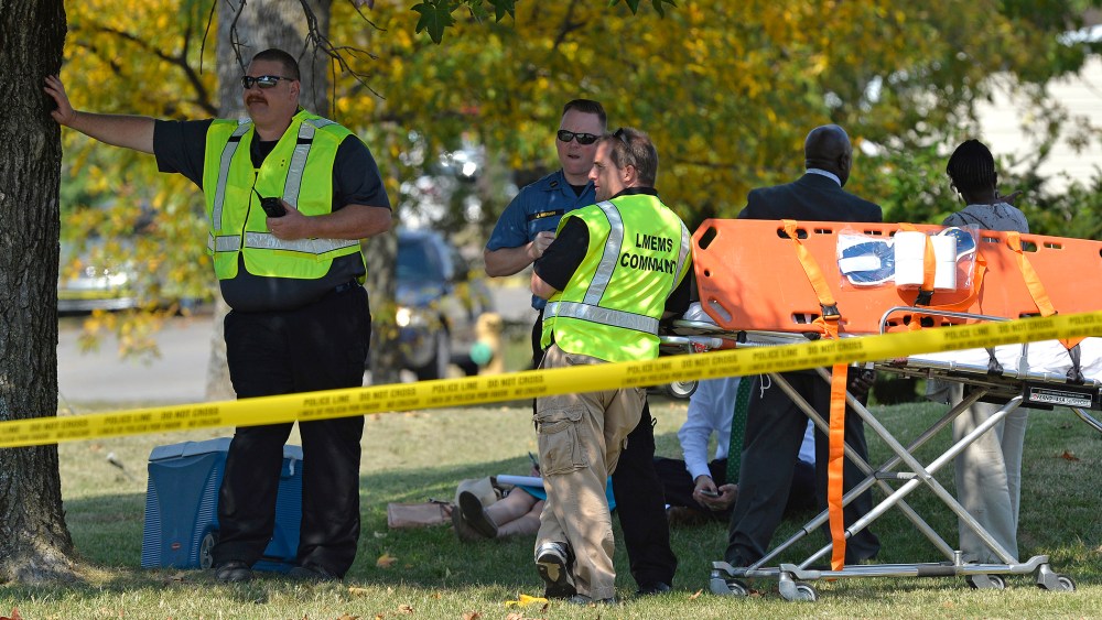 Members of the Louisville Metro Emergency Medical Services wait as units of the Louisville SWAT team search Fern Creek High School Tuesday, Sept. 30, 2014 in Louisville, Ky.