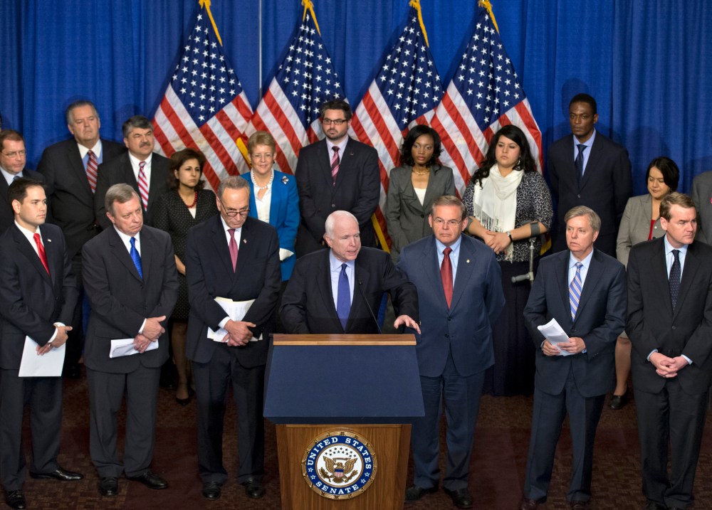 Sen. John McCain, R-Ariz., center, speaks as immigration reform legislation as outlined by the Senate's bipartisan "Gang of Eight" that would create a path for the nation's 11 million unauthorized immigrants to apply for U.S. citizenship, Thursday,...