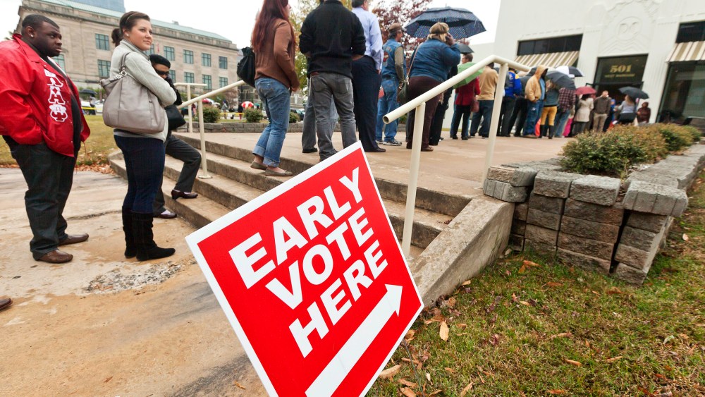Arkansas voters line up in the rain at an early voting poling place in Little Rock, Ark., Nov. 5, 2012.