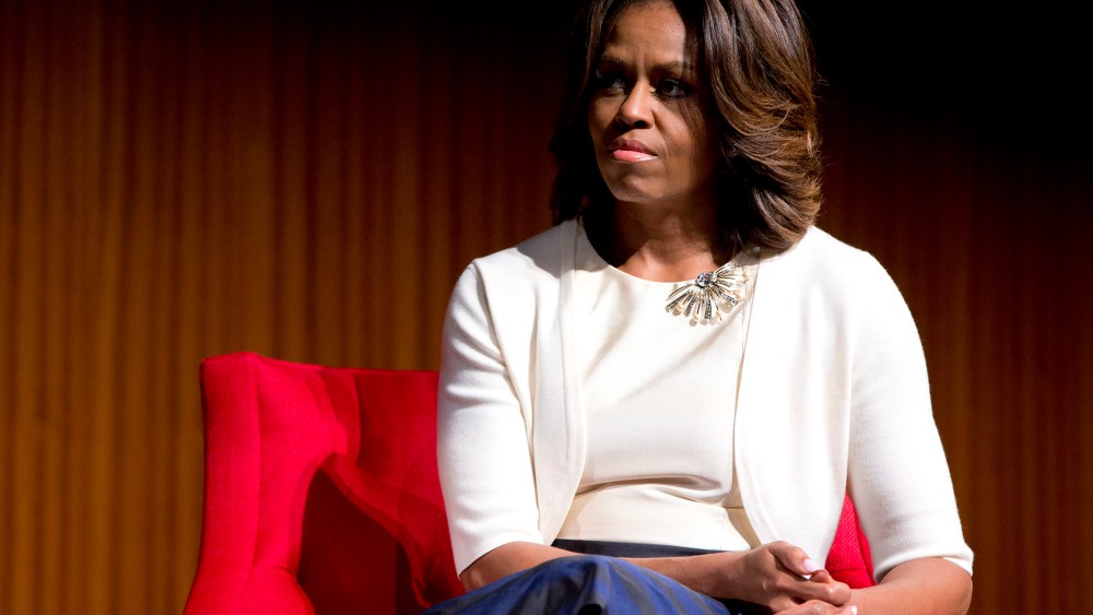 First lady Michelle Obama looks to President Barack Obama as he speaks at the LBJ Presidential Library, April 10, 2014, in Austin, Texas.