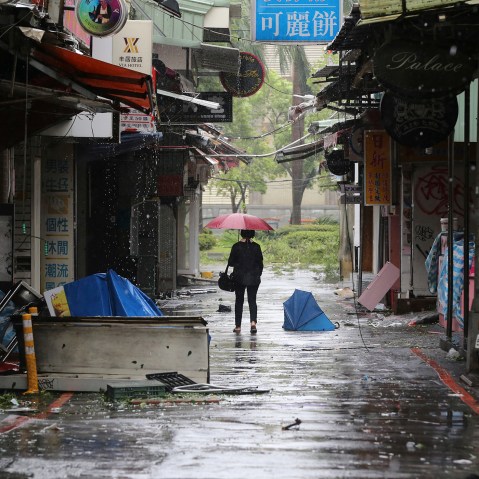 A woman walks down a back alley filled with debris from Typhoon Soudelor in Taipei, Taiwan, Aug. 8, 2015, after Soudelor brought heavy rains and strong winds to the island. (Photo by Wally Santana/AP)