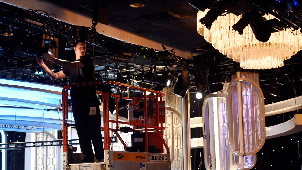 Crew member Chris Lopez adjusts lights in the ballroom during the 73rd Annual Golden Globe Awards Preview Day at the Beverly Hilton, Jan. 7, 2016, in Beverly Hills, Calif. (Photo by Chris Pizzello/Invision/AP)