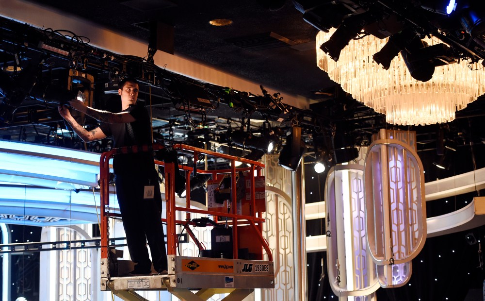 Crew member Chris Lopez adjusts lights in the ballroom during the 73rd Annual Golden Globe Awards Preview Day at the Beverly Hilton, Jan. 7, 2016, in Beverly Hills, Calif. (Photo by Chris Pizzello/Invision/AP)