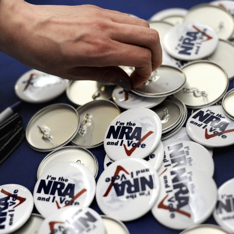 A woman grabs a button during a "lobby day" held by the National Rifle Association and other gun rights groups at the Legislative Office Building in Hartford, Conn., Monday, March 11, 2013.