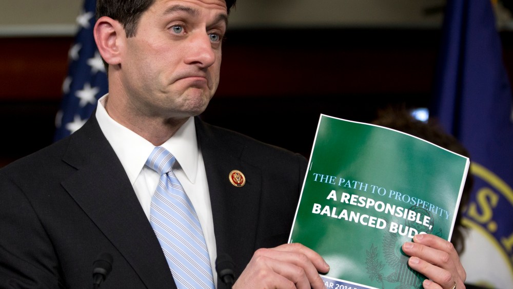 House Budget Committee Chairman Rep. Paul Ryan, R-Wis., holds up a copy of the 2014 Budget Resolution as he speaks during a news conference on Capitol Hill in Washington, Tuesday, March 12, 2013. (AP Photo/Carolyn Kaster)