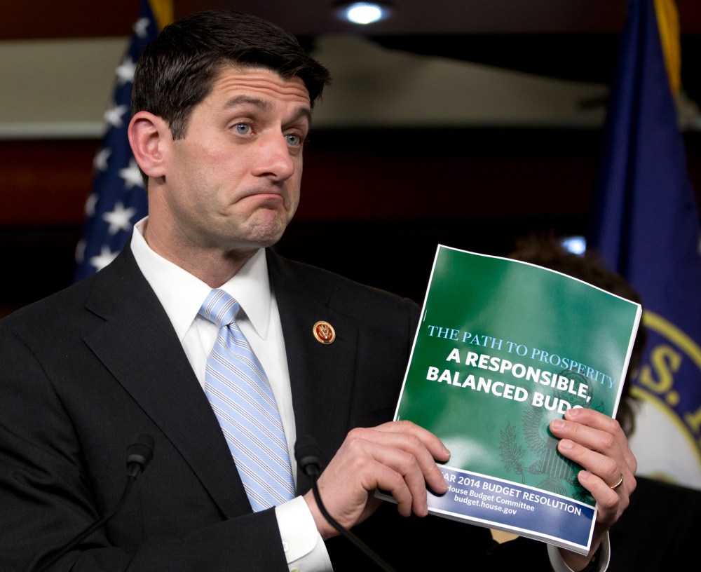House Budget Committee Chairman Rep. Paul Ryan, R-Wis., holds up a copy of the 2014 Budget Resolution as he speaks during a news conference on Capitol Hill in Washington, Tuesday, March 12, 2013. (AP Photo/Carolyn Kaster)
