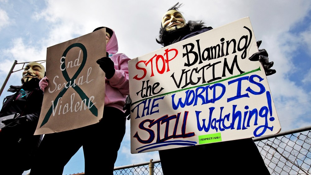 Protesters hold signs outside of the Jefferson County Justice Center and Jail in Steubenville, Ohio, on Wednesday, March 13, 2013.