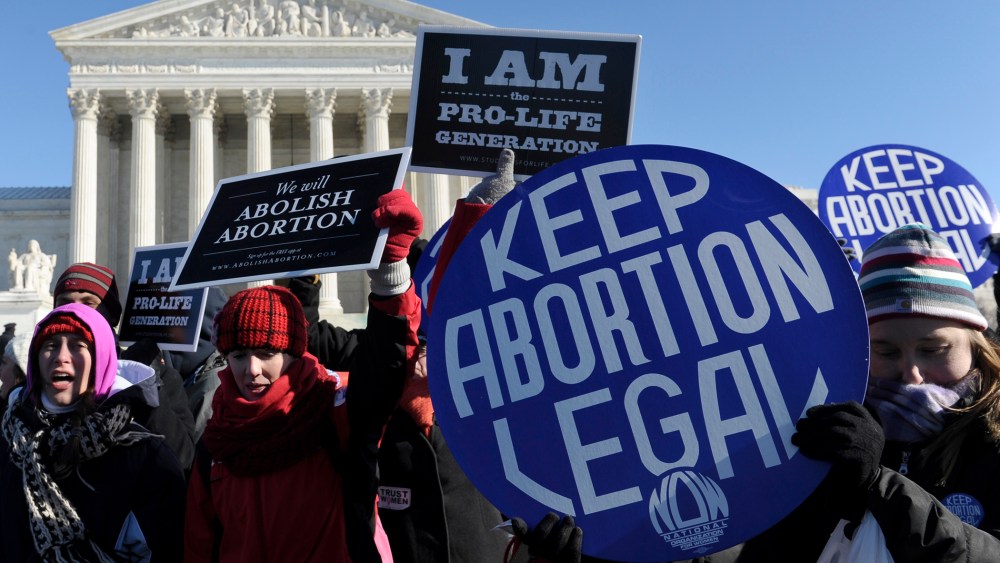 Pro-abortion and anti-abortion protestors rally outside the Supreme Court in Washington, D.C., Jan. 22, 2014.