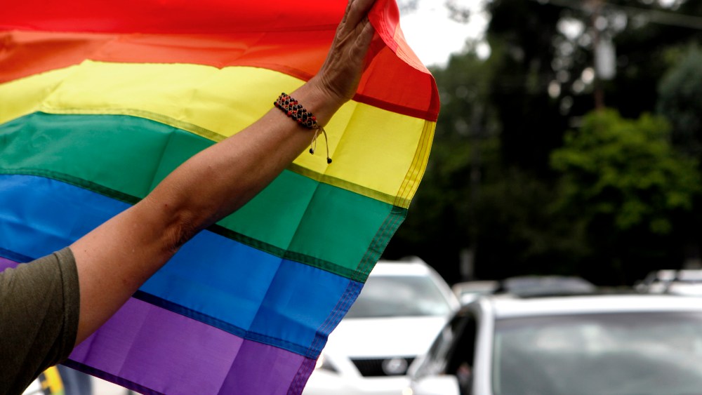 Atlanta resident River Moore holds up a rainbow flag while celebrating of the U.S. Supreme Court's rulings same-sex marriage on June 26, 2013, in Atlanta, Ga.