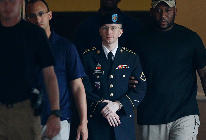 Army Pfc. Bradley Manning, second from right, is escorted to a waiting security vehicle outside of a courthouse in Fort Meade, Md., Monday, July 15, 2013, after appearing for a hearing at his court martial. (Photo by Patrick Semansky/AP)