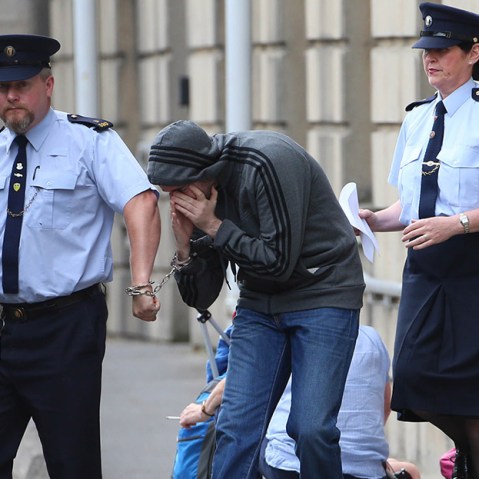 Eric Eoin Marques is led away from the High Court in Dublin after authorities in the United States have formally requested his extradition. Picture date: Thursday August 15, 2013. (Photo by Niall Carson/PA Wire/AP)