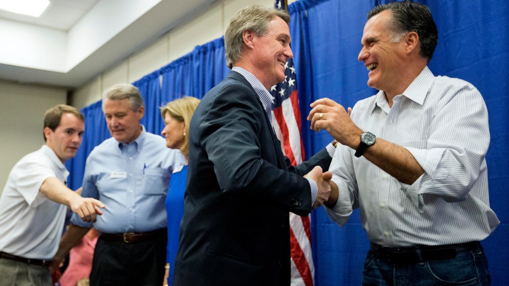 Former Republican presidential nominee Mitt Romney, right, embraces Georgia Republican U.S. Senate candidate David Perdue during a campaign event. on Oct. 29, 2014, in Augusta, Ga. (David Goldman/AP)