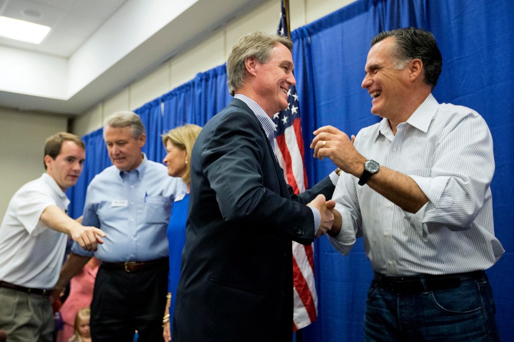 Former Republican presidential nominee Mitt Romney, right, embraces Georgia Republican U.S. Senate candidate David Perdue during a campaign event. on Oct. 29, 2014, in Augusta, Ga. (David Goldman/AP)
