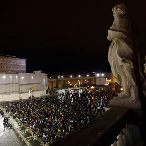 People gather in St. Peter's Square at the Vatican, Tuesday, March 12, 2013. Cardinals from around the globe locked themselves inside the Sistine Chapel on Tuesday to choose a new leader for the world's 1.2 billion Catholics and their troubled church. ...