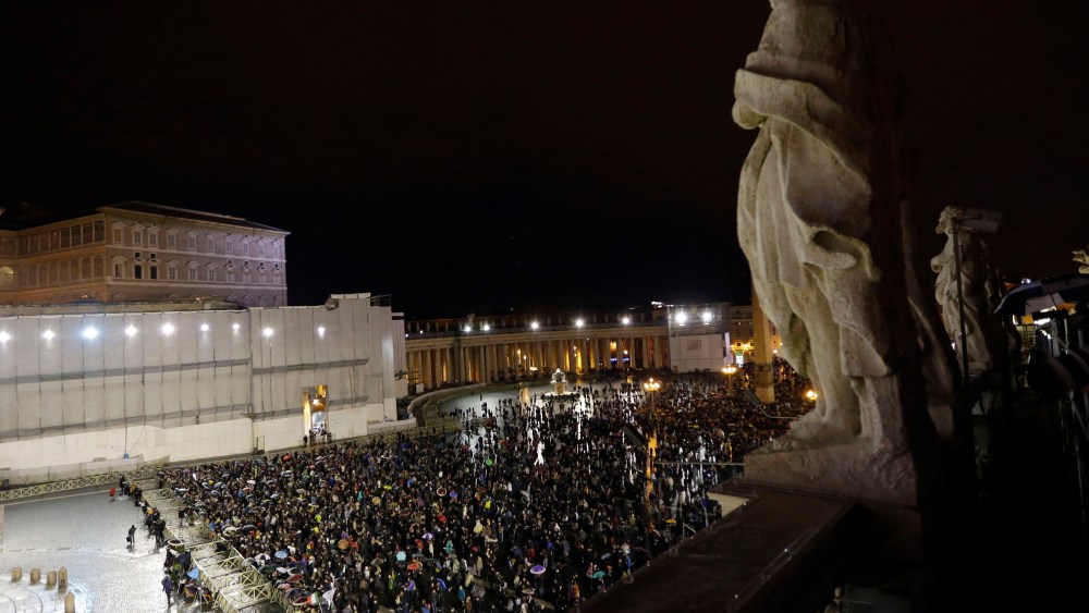 People gather in St. Peter's Square at the Vatican, Tuesday, March 12, 2013. Cardinals from around the globe locked themselves inside the Sistine Chapel on Tuesday to choose a new leader for the world's 1.2 billion Catholics and their troubled church. ...
