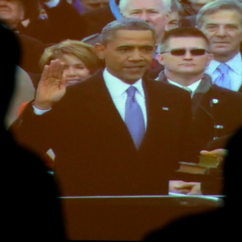 Visitors to the Brown v. Board of Education National Historic Site watch a broadcast of the inauguration of President Barack Obama Monday, Jan. 21, 2013, in Topeka, Kan. (AP Photo/Charlie Riedel)