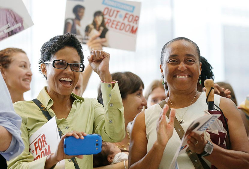 Gail Lloyd, left, and her partner of 17 years Angela Gillem react to an announcement by Pennsylvania Attorney Gen. Kathleen Kane during a news conference at the National Constitution Center, Thursday, July 11, 2013, in Philadelphia. (Photo by Matt...